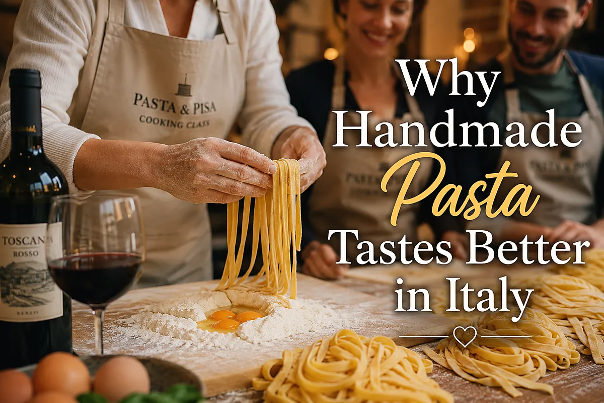 Chef lifting fresh tagliatelle with a glass of red wine on the table