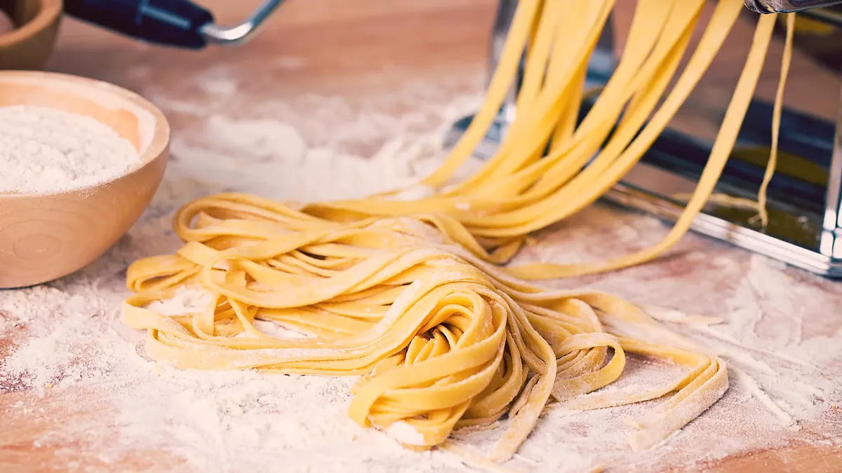 Fresh tagliatelle on a floured board