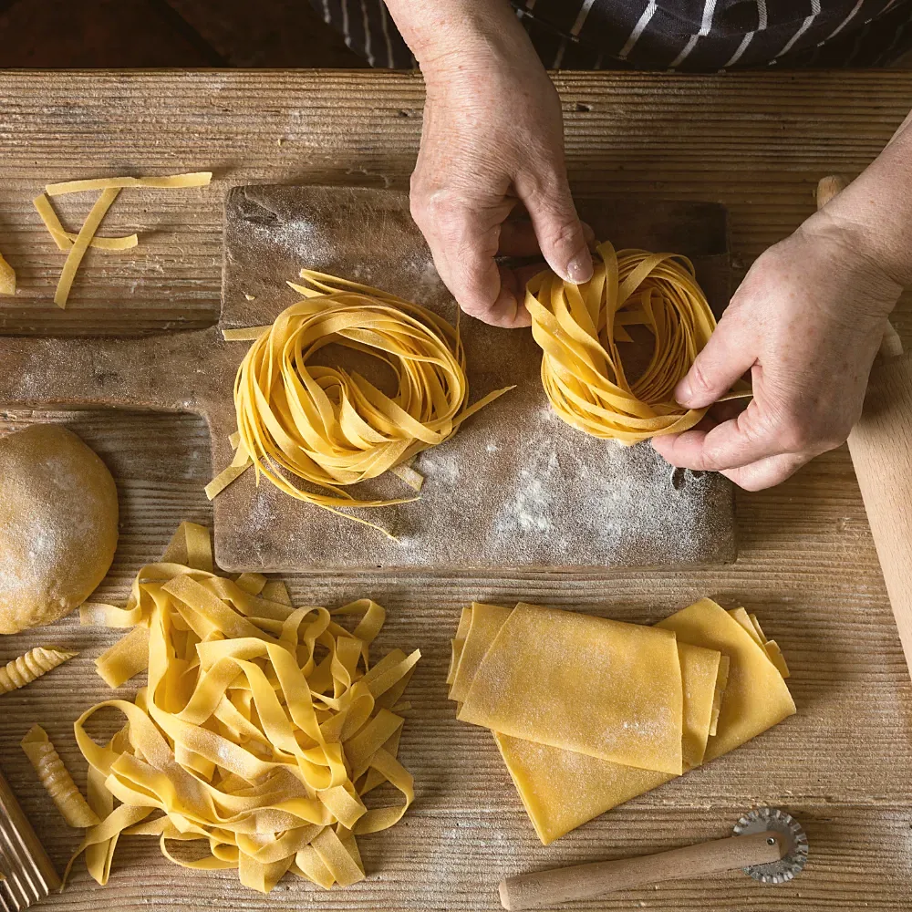Different shapes of fresh pasta on the board